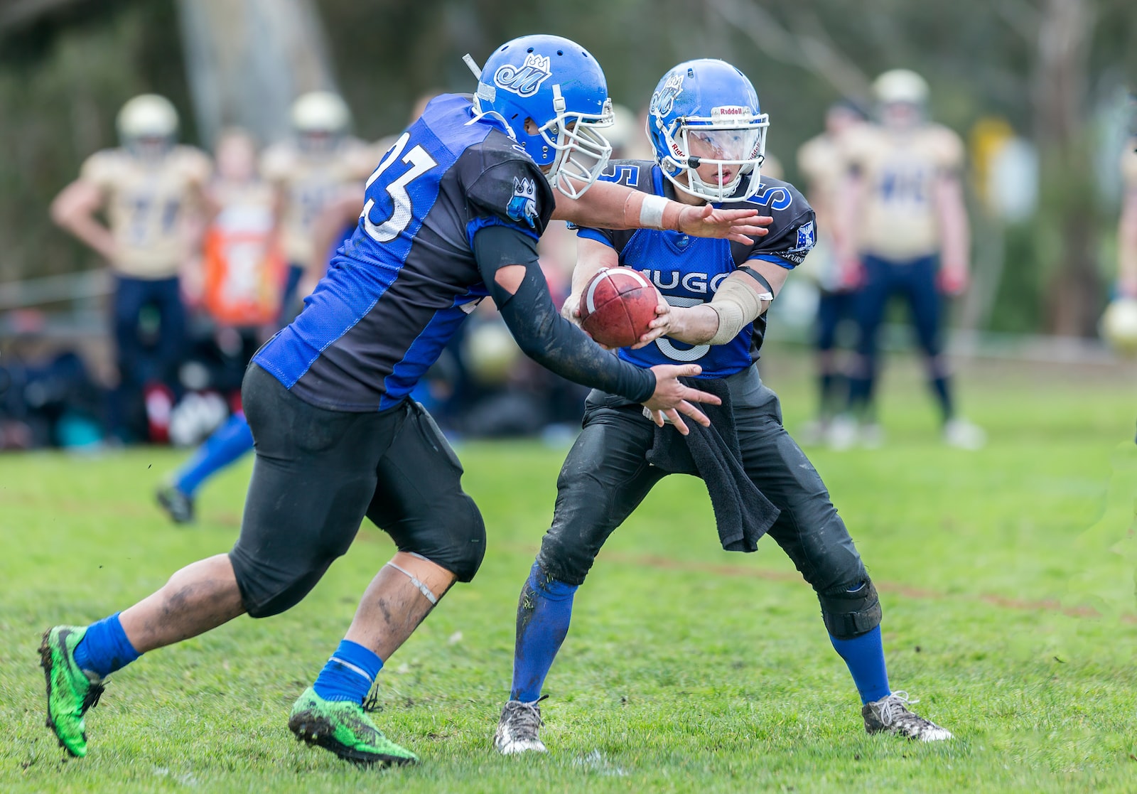 time-lapse photography of men playing football in field