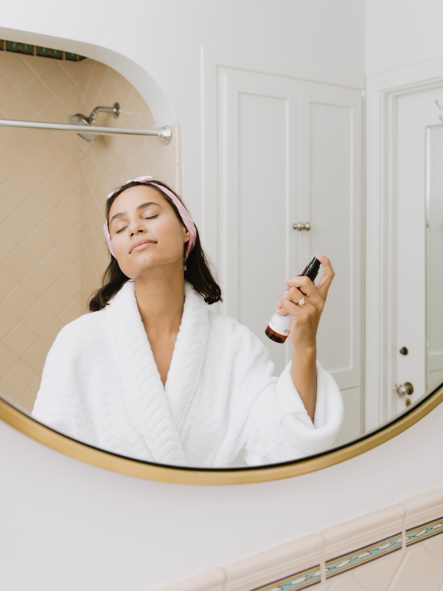 sustainable beauty products woman in white bathrobe holding smartphone